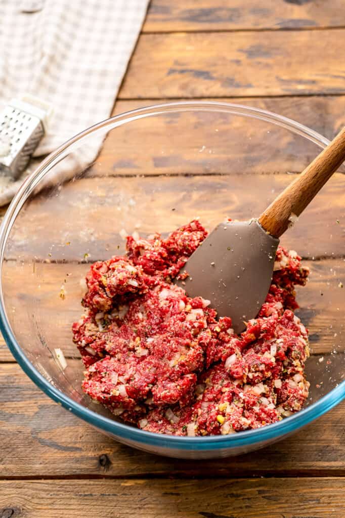 Glass bowl with mixture for baked meatballs