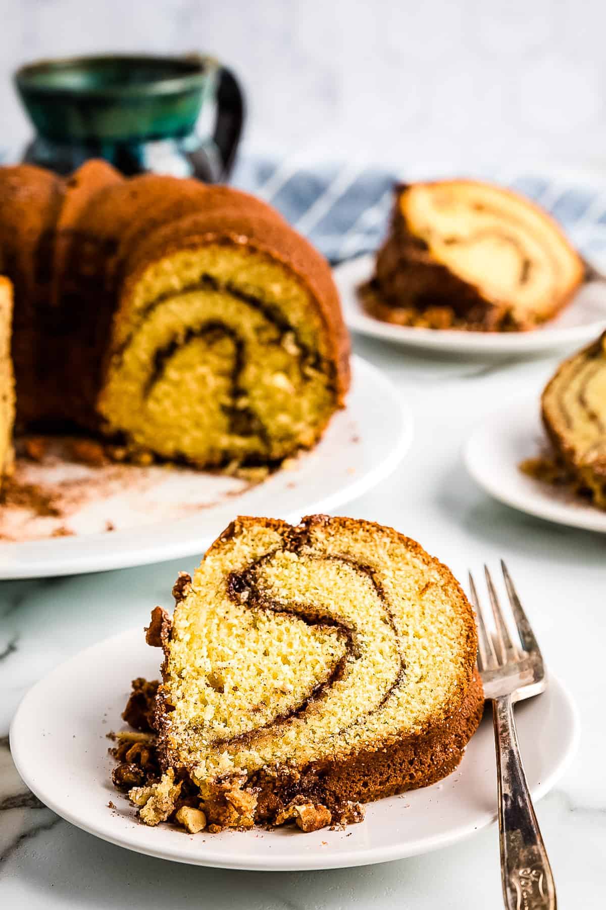 Bundt Coffee Cake Slice on plate with cake in background