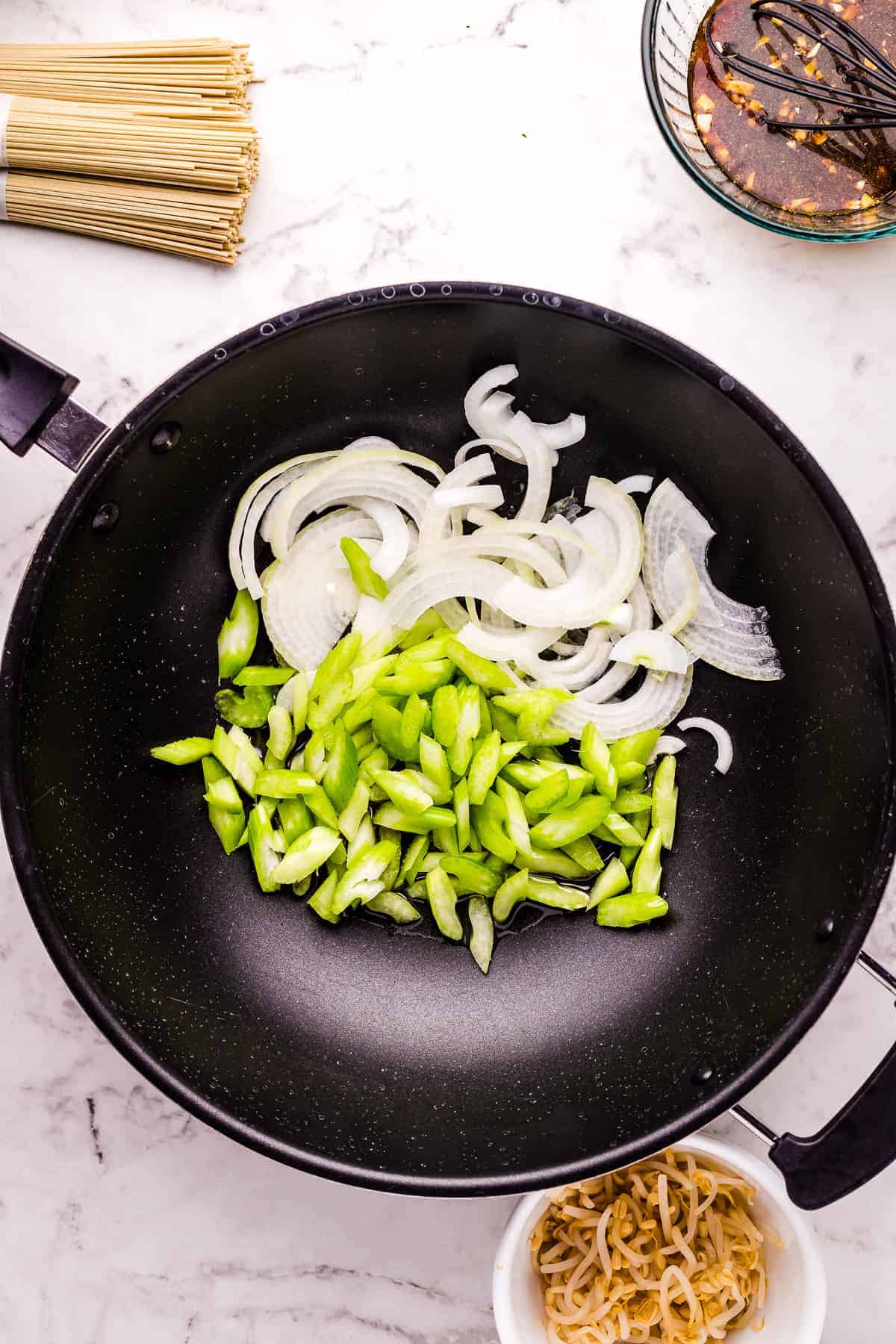 Sliced cabbage and onions in black skillet