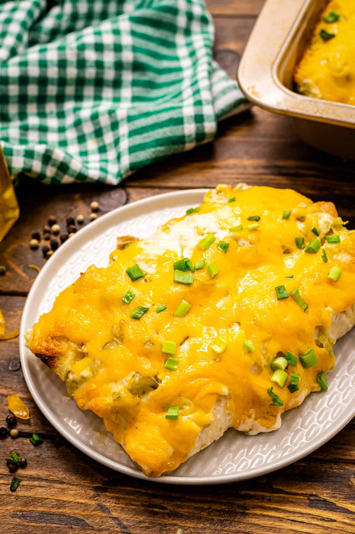 Creamy Chicken Enchiladas are on a white plate