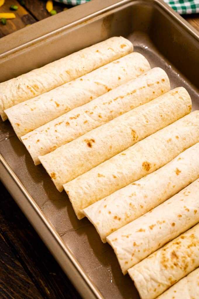A pan of enchiladas with flour tortillas