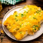 Square cropped image of chicken enchiladas on plate