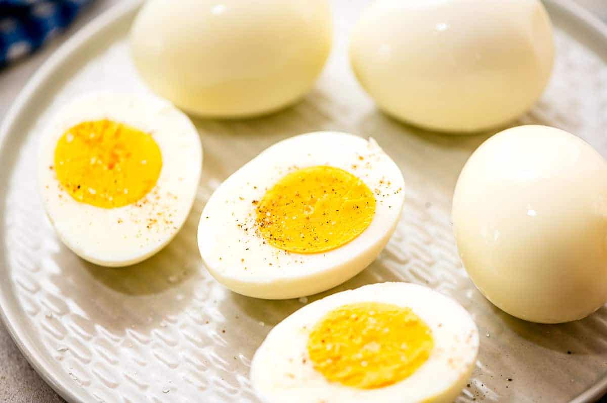 A white plate with three Hard Boiled Eggs cut in half