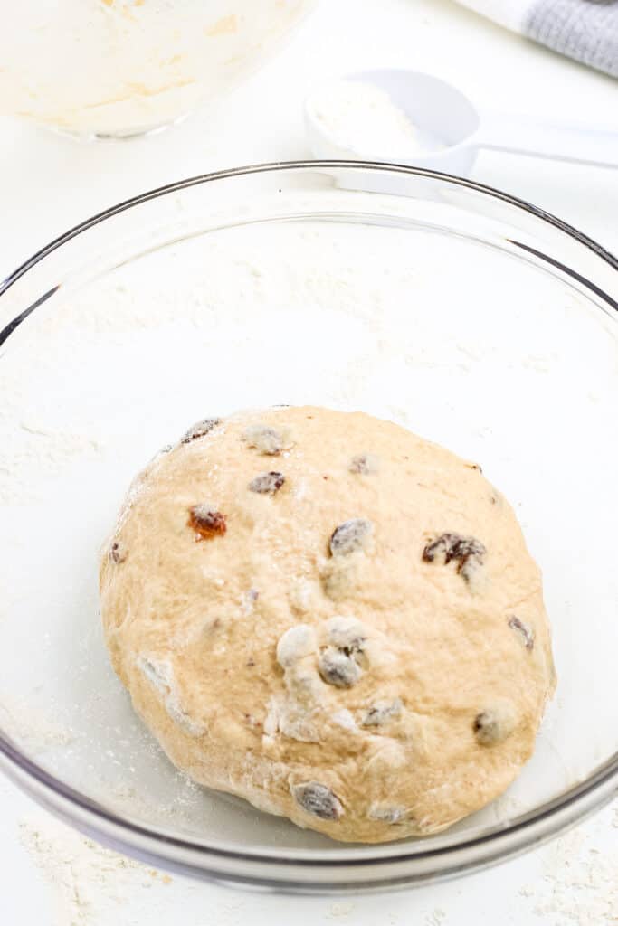 Hot Cross buns dough proofing in glass bowl