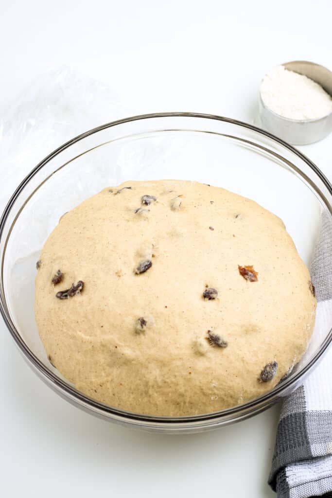 Glass bowl with proofed dough for hot cross buns