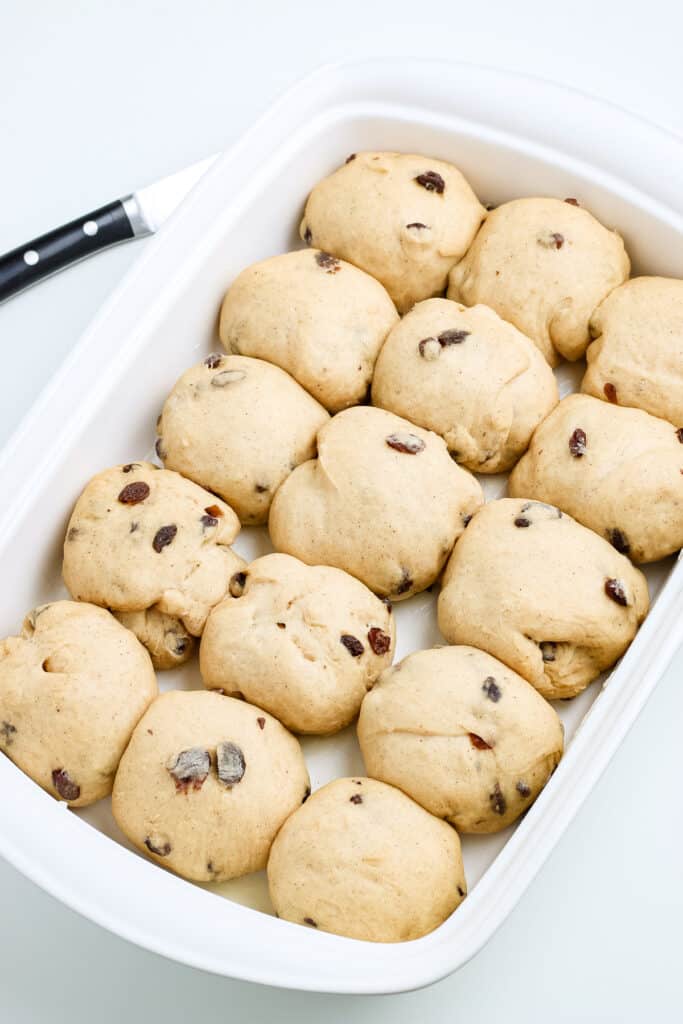 Pan of proofed hot cross buns