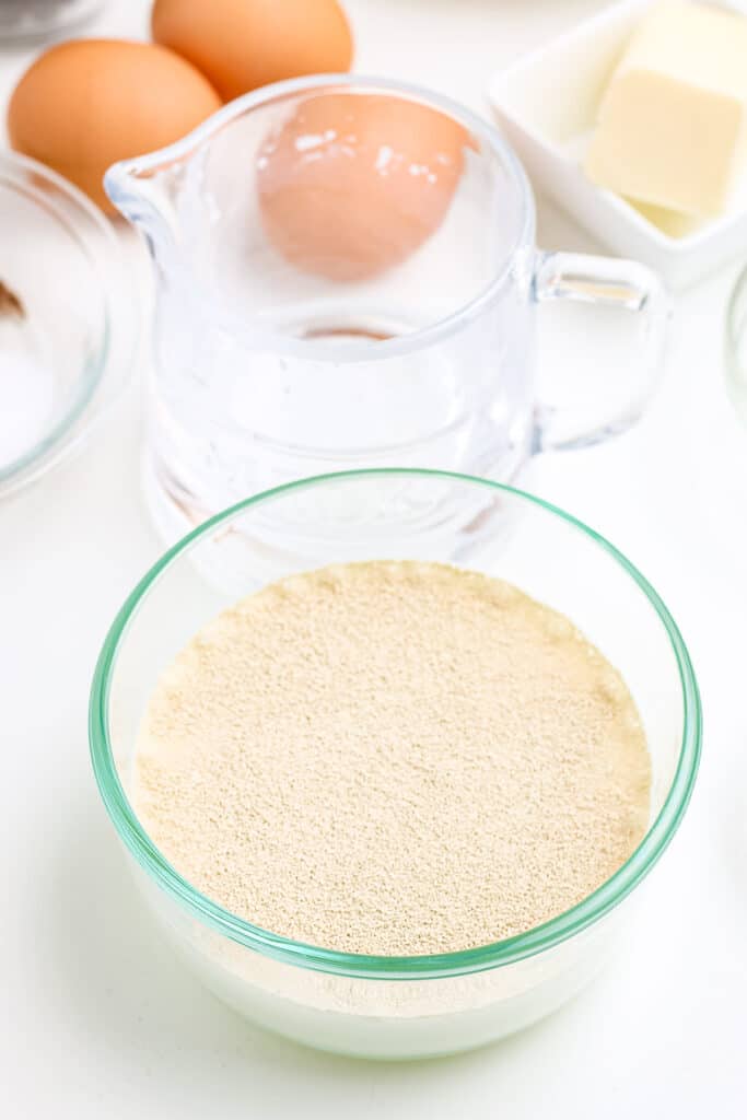 Glass bowl with yeast and milk