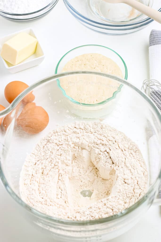 Flour mixture to make buns in glass bowl