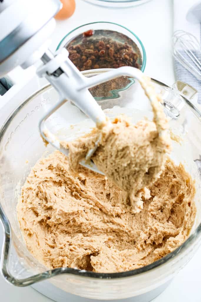 Dough for hot cross buns mixed up in stand mixer bowl