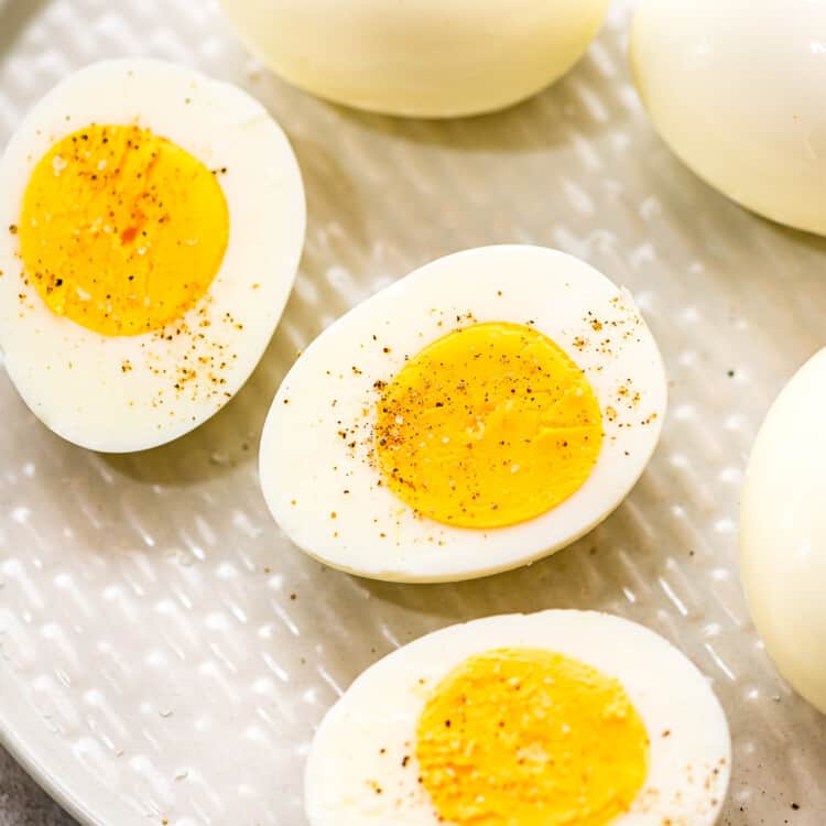 Hard Boiled Eggs cut in half sprinkled with salt and pepper on plate