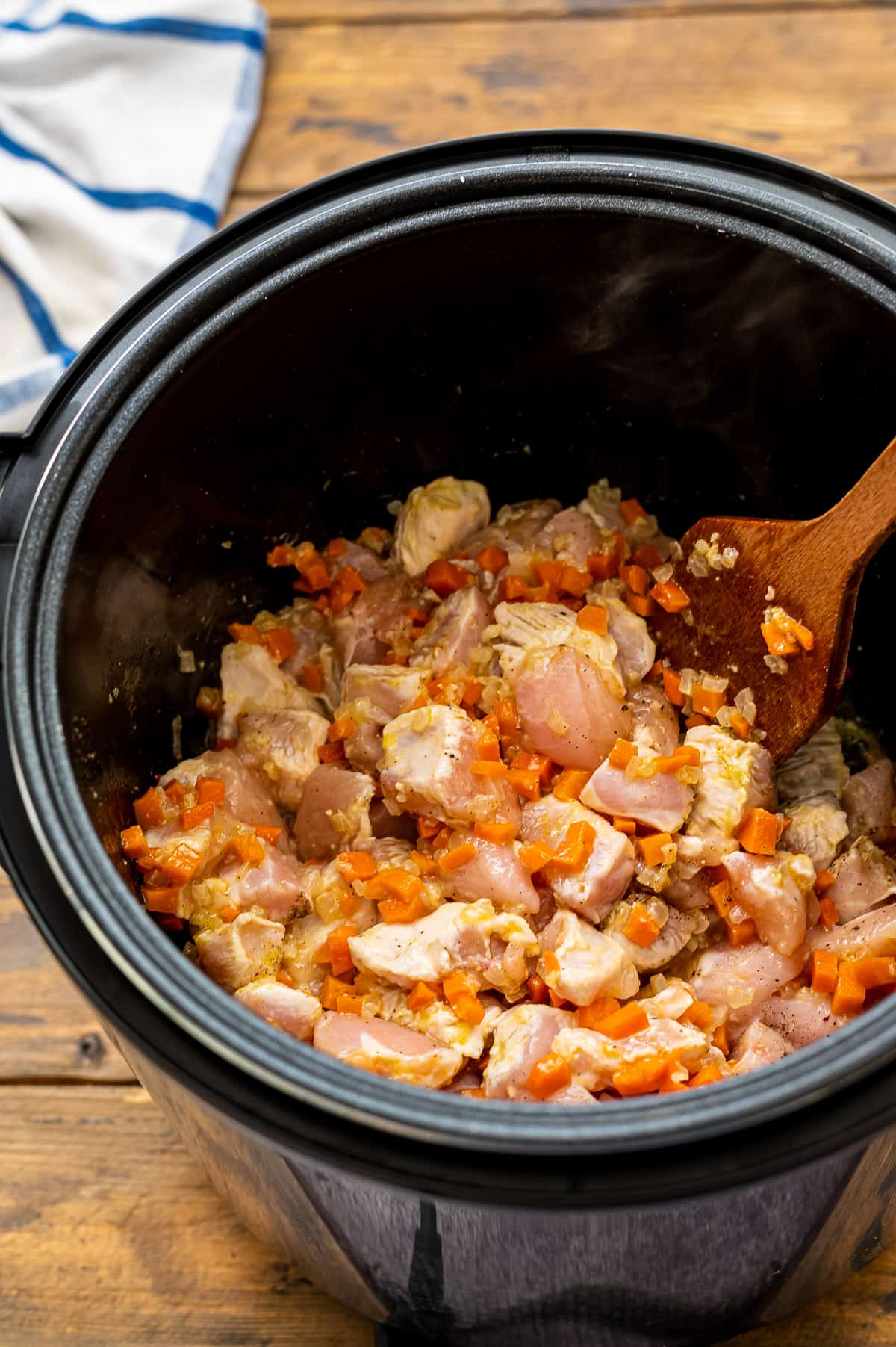 Instant Pot with sauteed chicken and carrots in it.