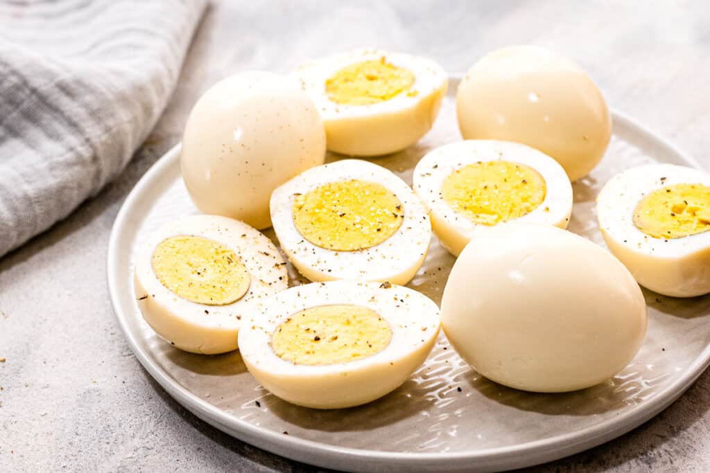 Plate with hard boiled eggs that are cut open and seasoned with pepper