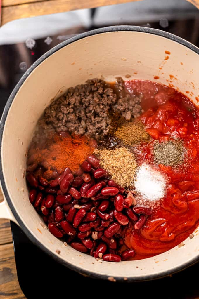 Dutch oven with ingredients in it for chili mac before stirring