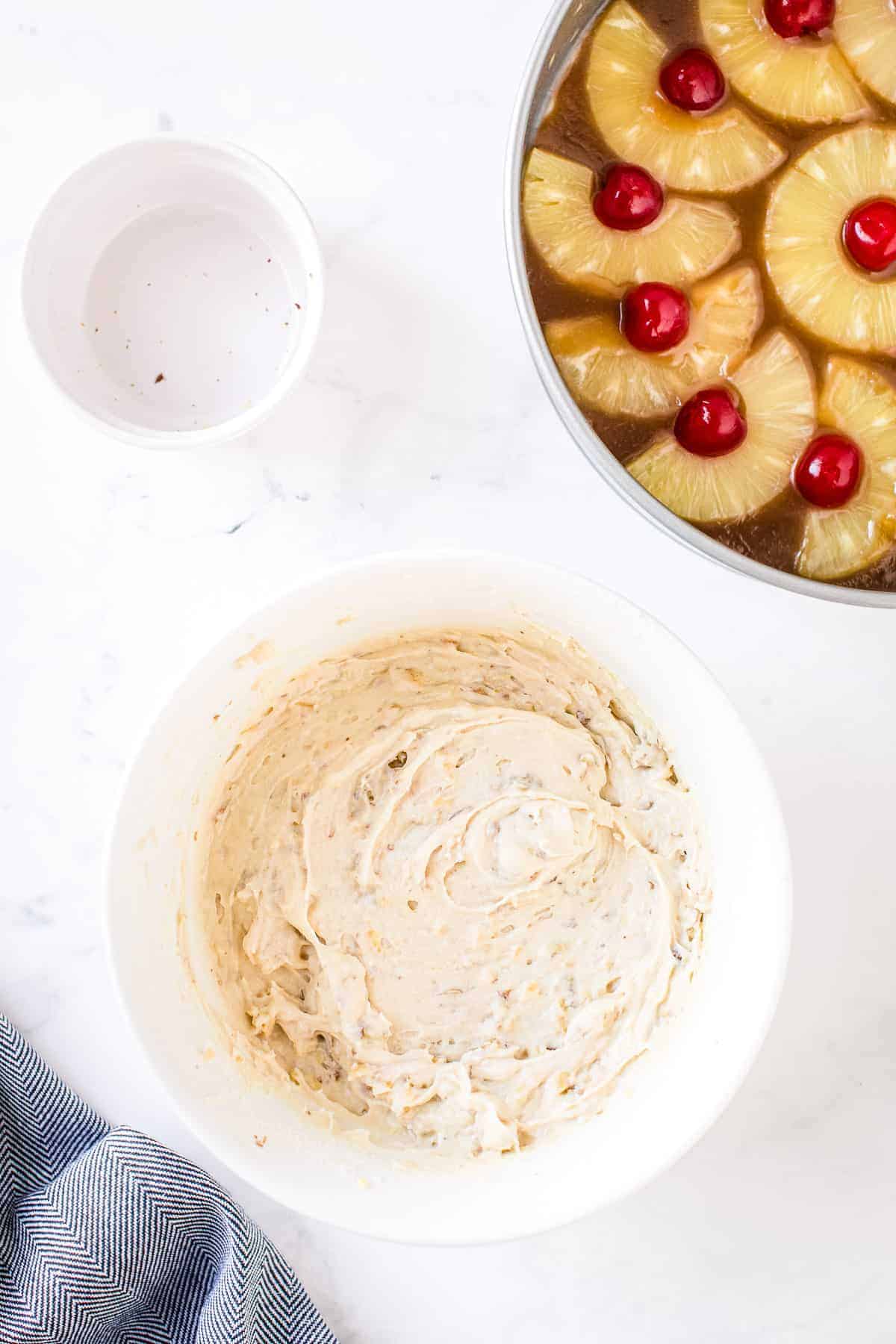 White bowl with prepared batter for pineapple upside down cake