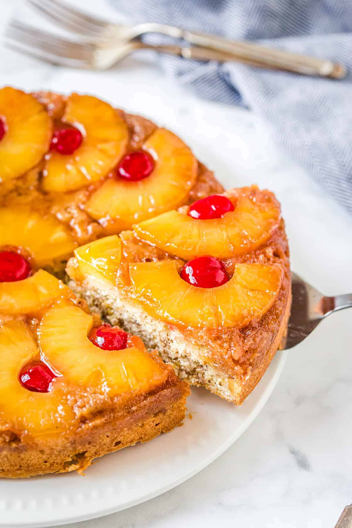 Pineapple Upside Down Cake with a slice being removed