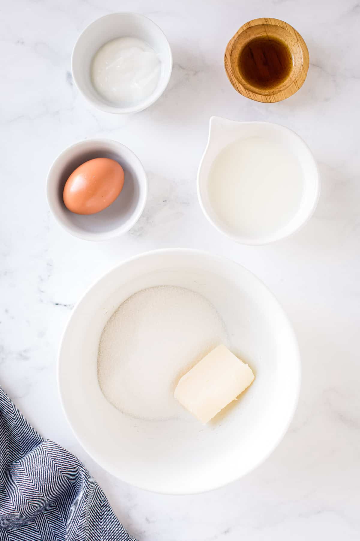 White bowl with butter and sugar in it before mixing