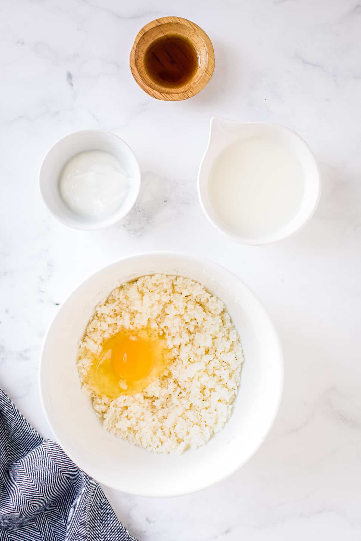 Creamed butter and sugar with egg on top of it before mixing