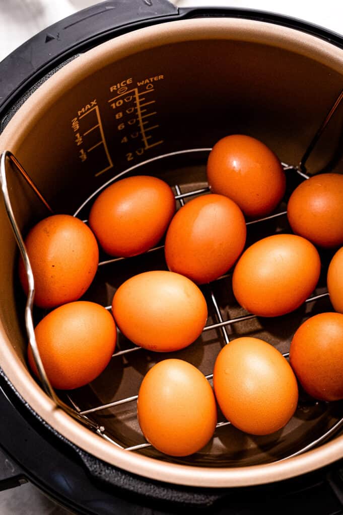 Instant Pot with eggs on a trivet inside.