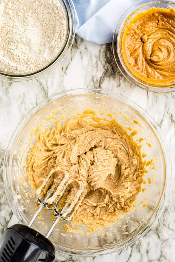 Hand mixer mixing peanut butter cookie dough