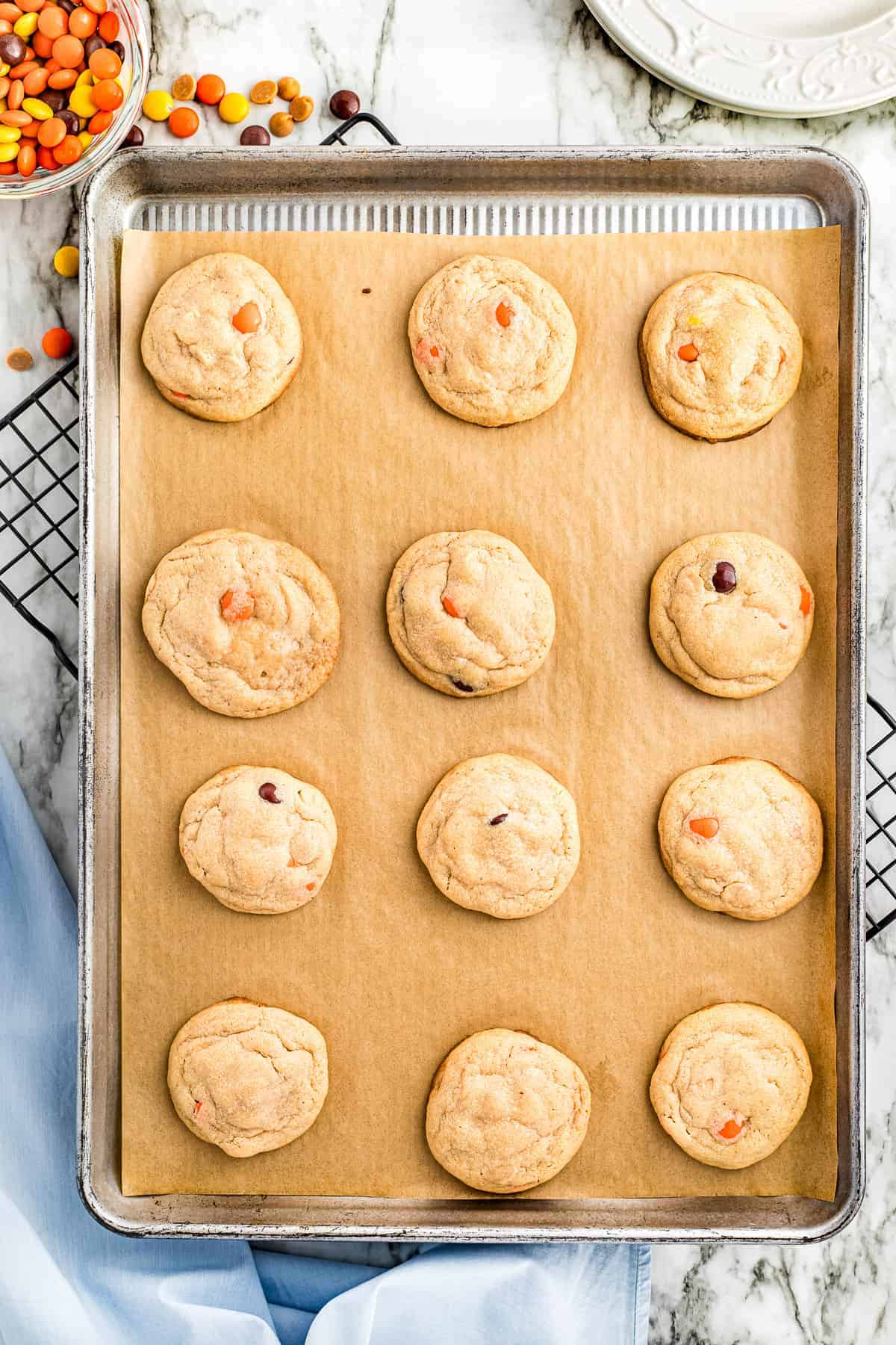 Overhead image of baked Reese's Pieces Cookies on sheet pan