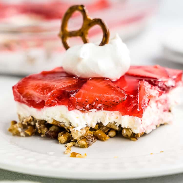 Slice of Strawberry Pretzel Salad on white plate