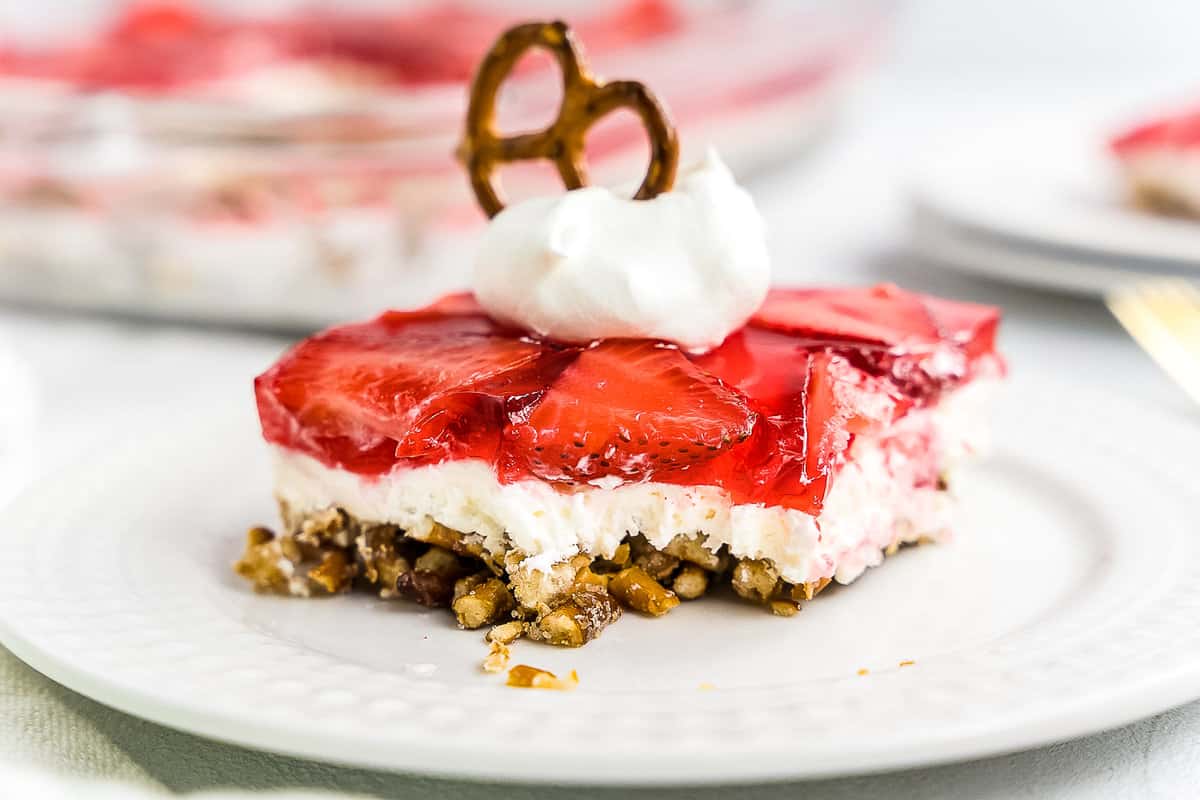 Slice of Strawberry Pretzel Salad on white plate