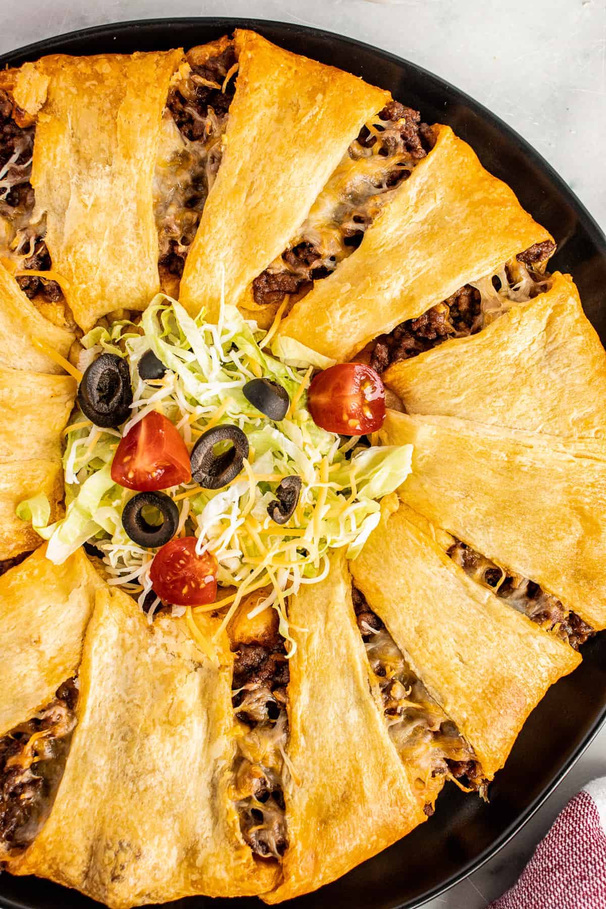 Taco Ring on dark plate with taco toppings in center