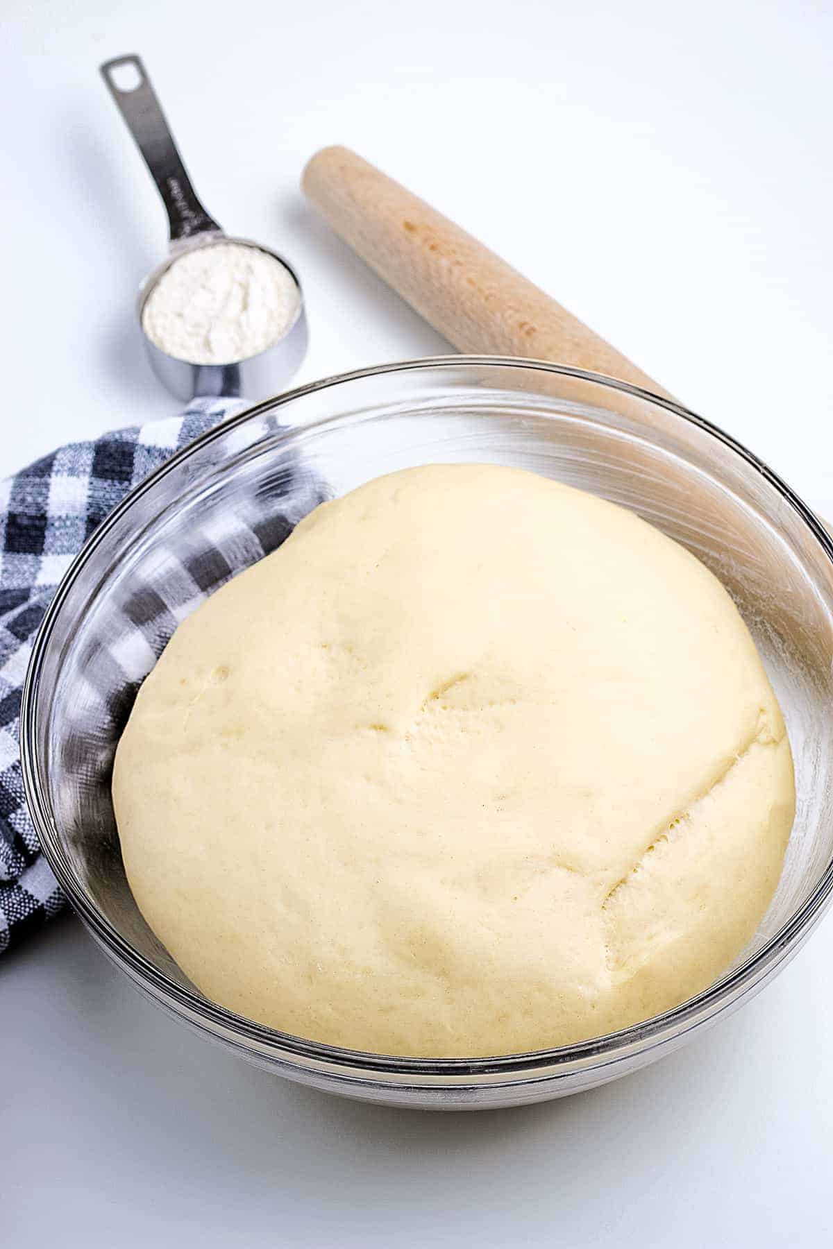 Proofed roll dough in glass bowl