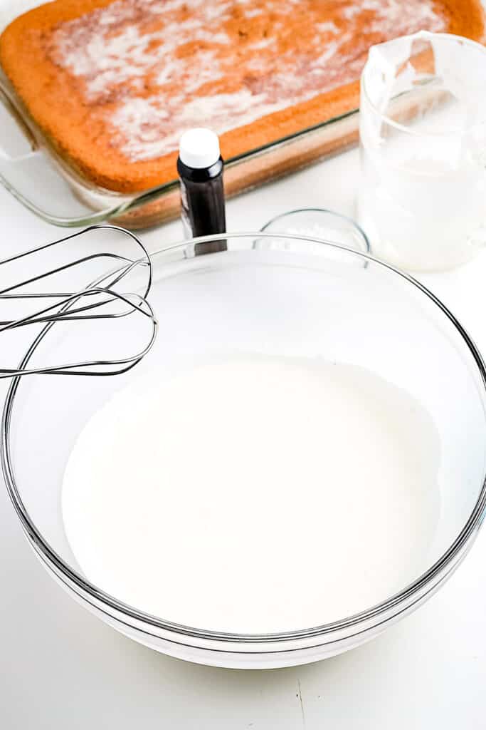 Whipping cream in glass bowl