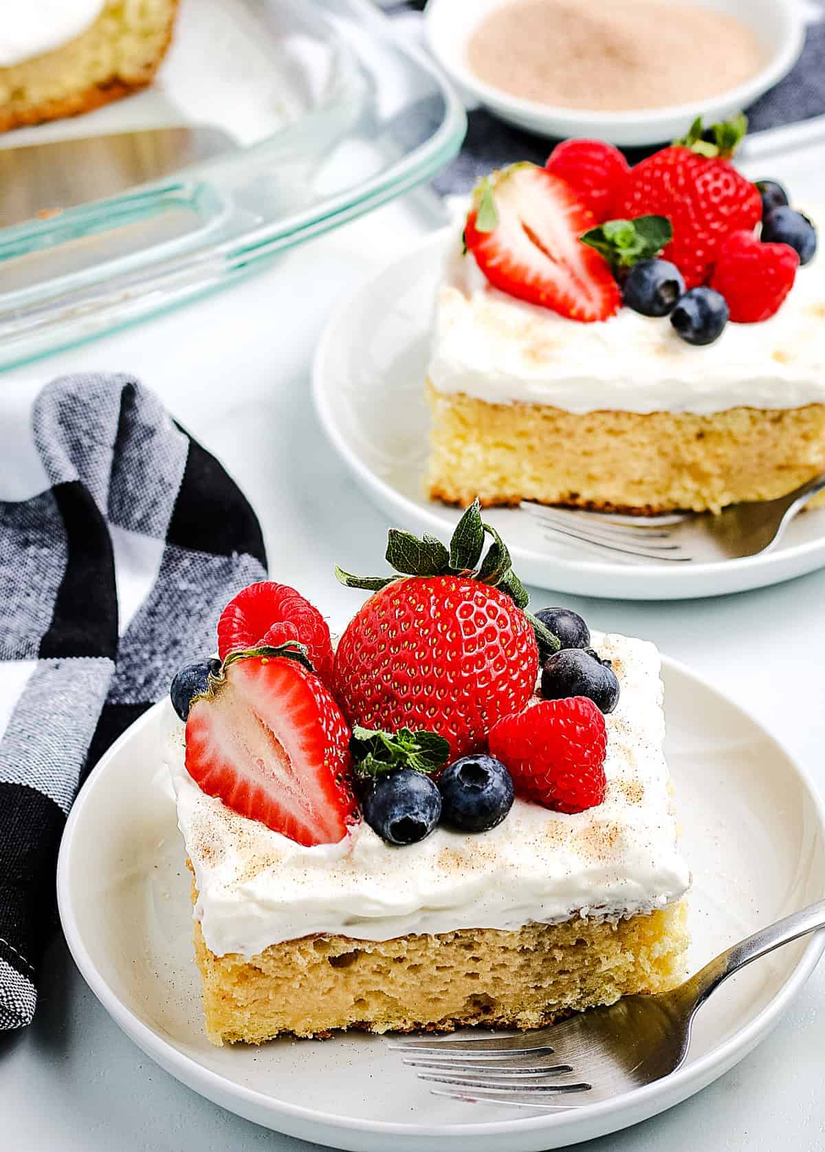 Tres Leche Cake pieces on white plates