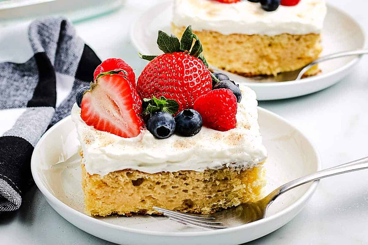 Tres Leche Cake on a white plate with fork