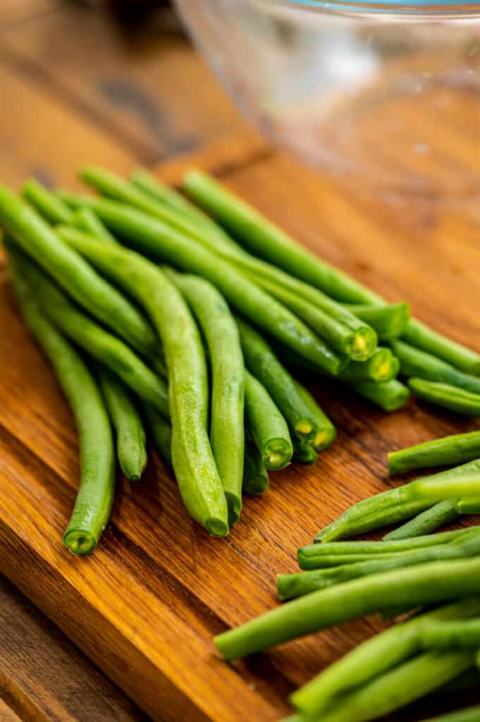 Trimmed Green Beans on a wood cutting board