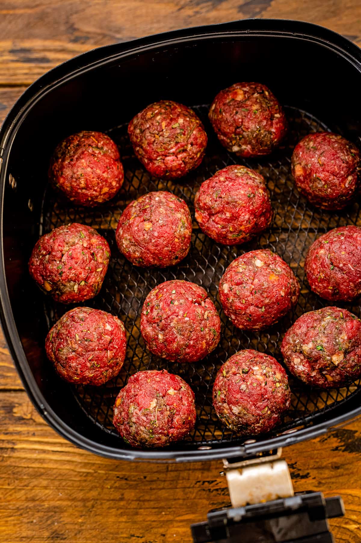 Air Fryer meatballs in air fryer basket before cooking