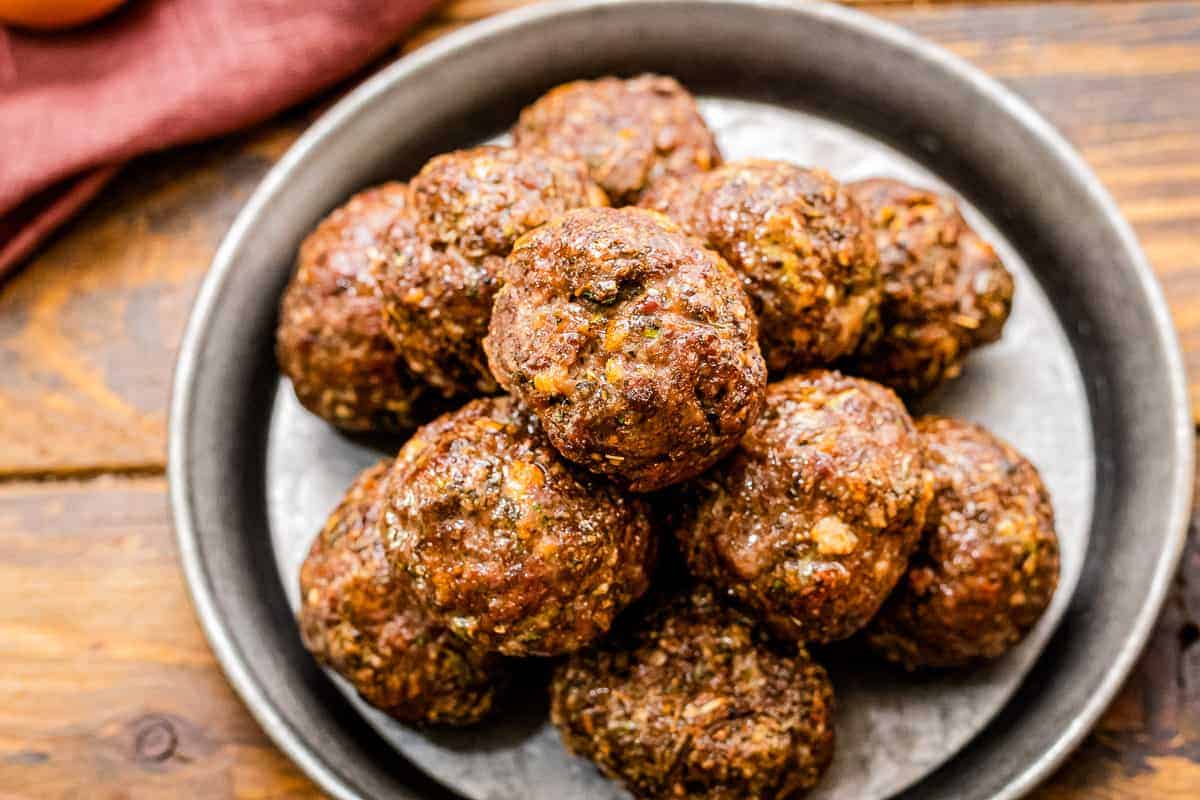 Overhead image of cooked meatballs on a plate