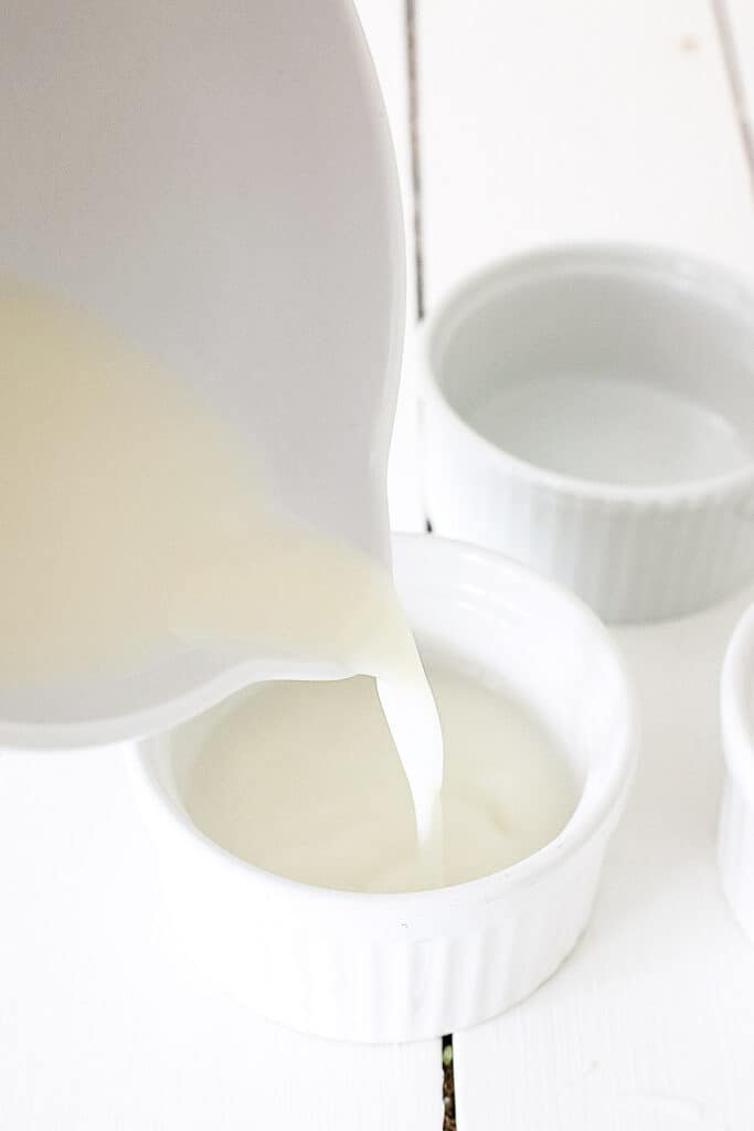 Pouring alcohol mixture into ramekin