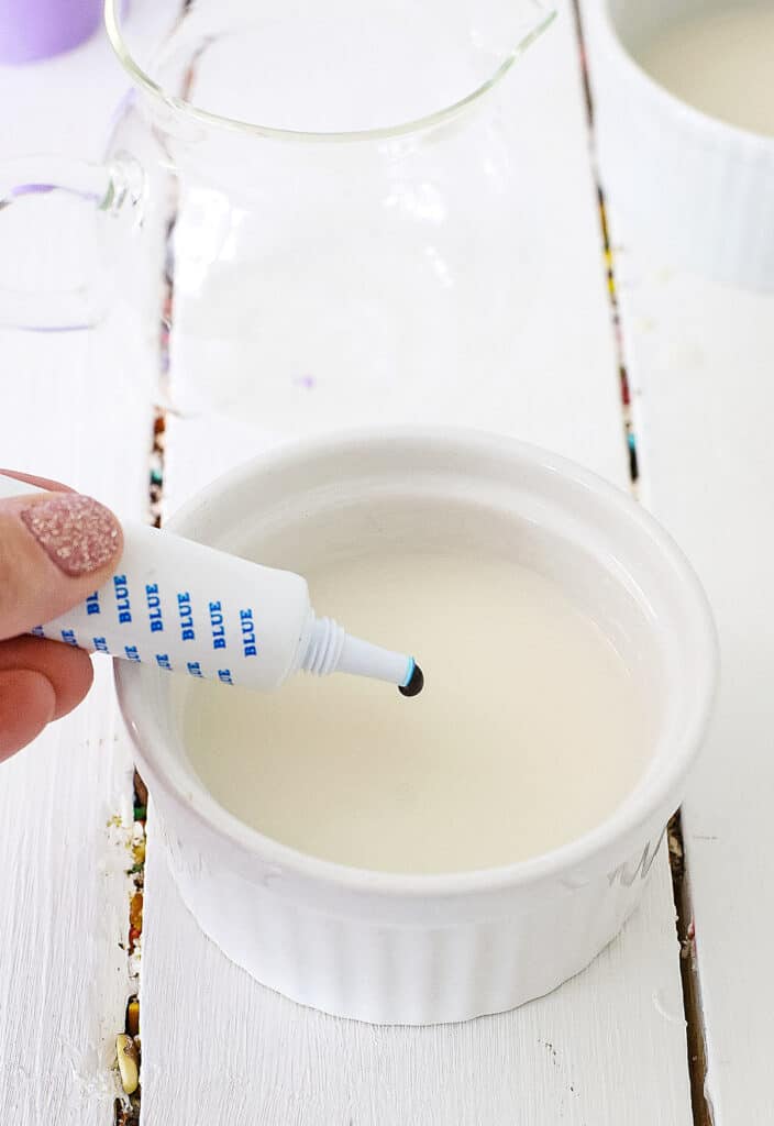 Dropping blue food coloring into alcohol mixture