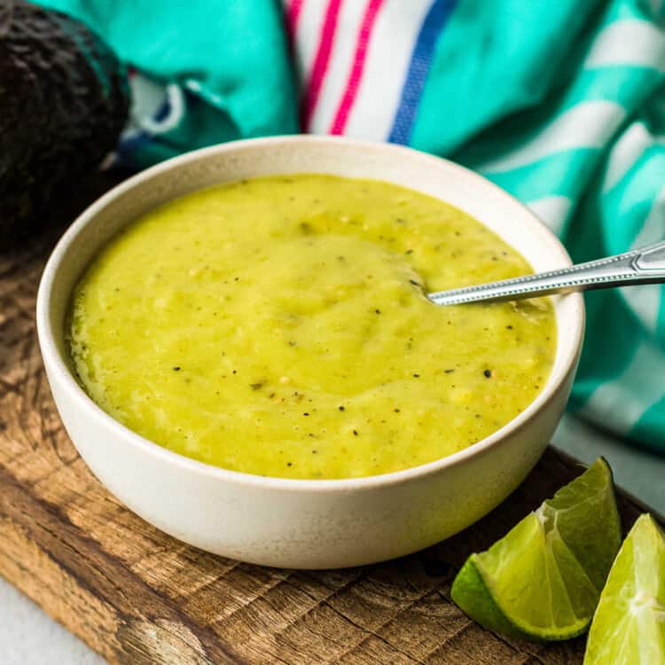 Square Cropped image of creamy avocado salsa in white bowl