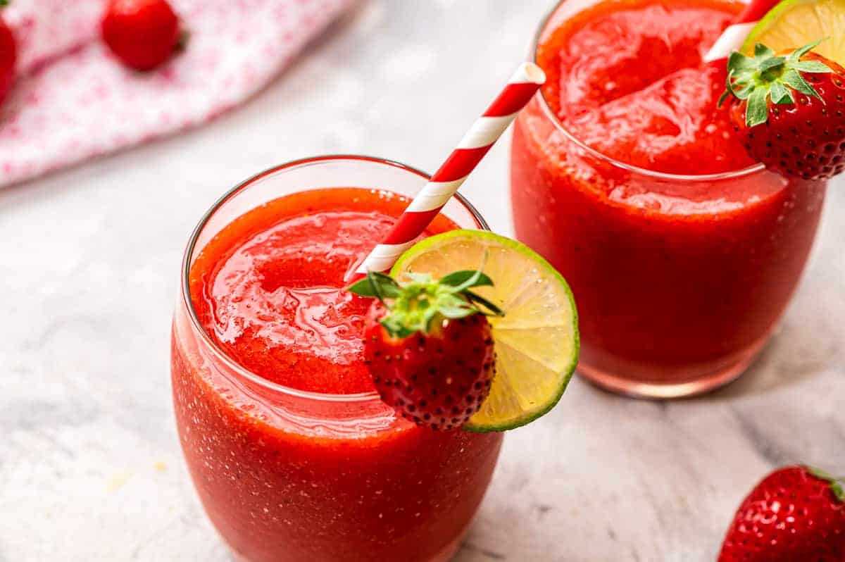 Two glasses of frozen strawberry daquiris