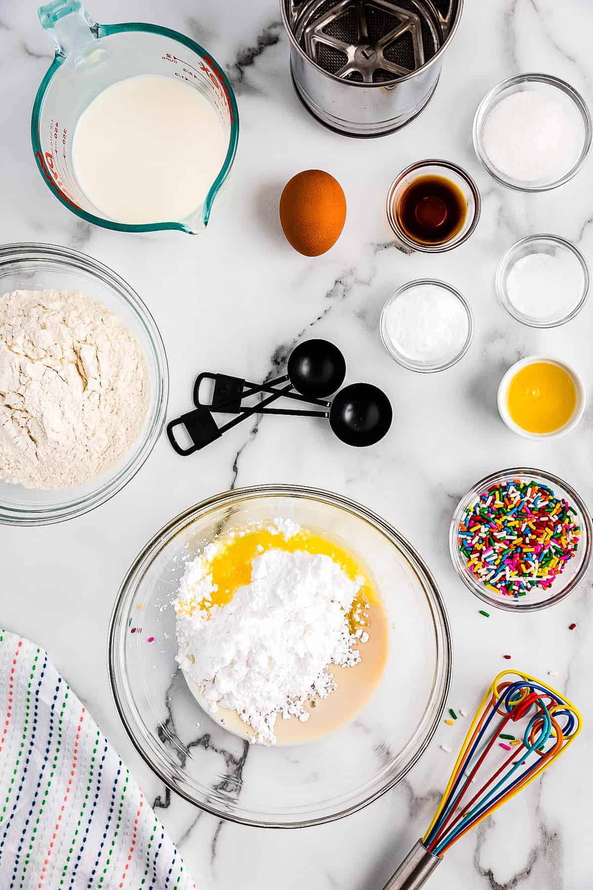 Ingredients in glass bowl to make frosting for funfetti pancakes