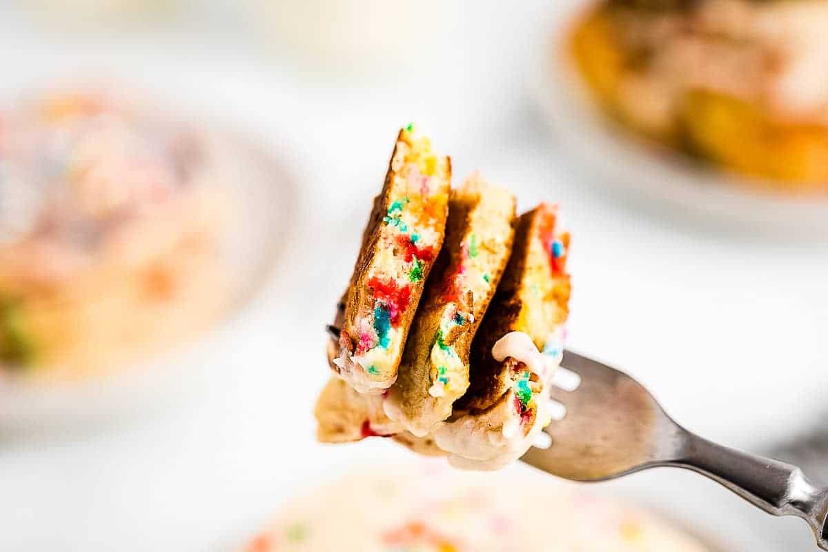 A fork with a bite of funfetti pancakes on it.
