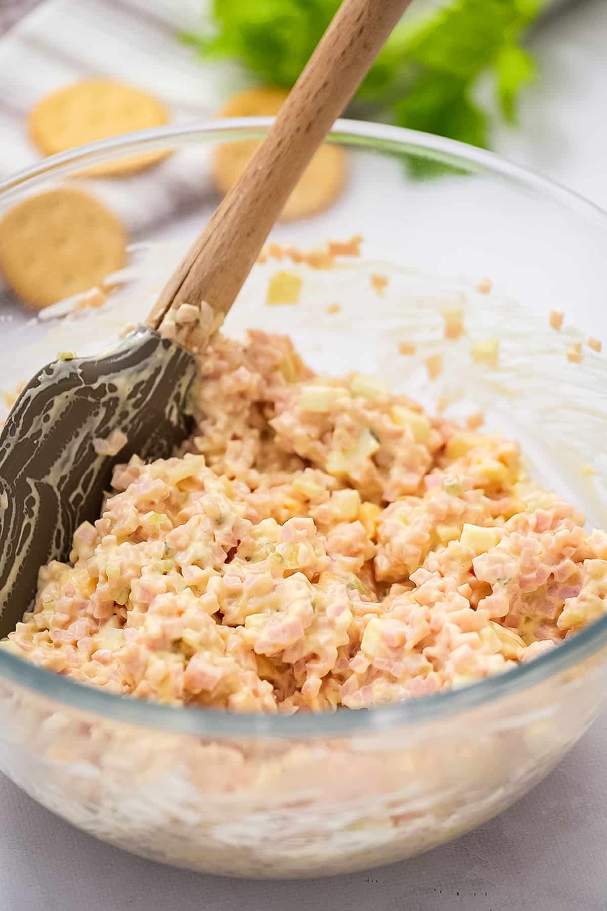 Spatula stirring a bowl of ham salad