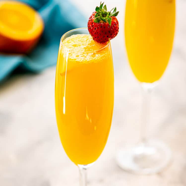 Close up image of a Mimosa with a strawberry garnish