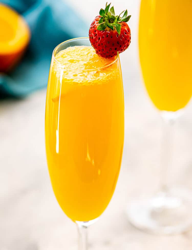 Close up image of a Mimosa with a strawberry garnish