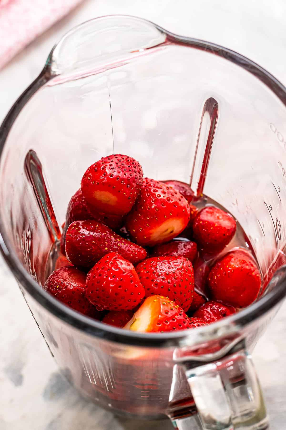 Blender with ingredients to make strawberry daquiris