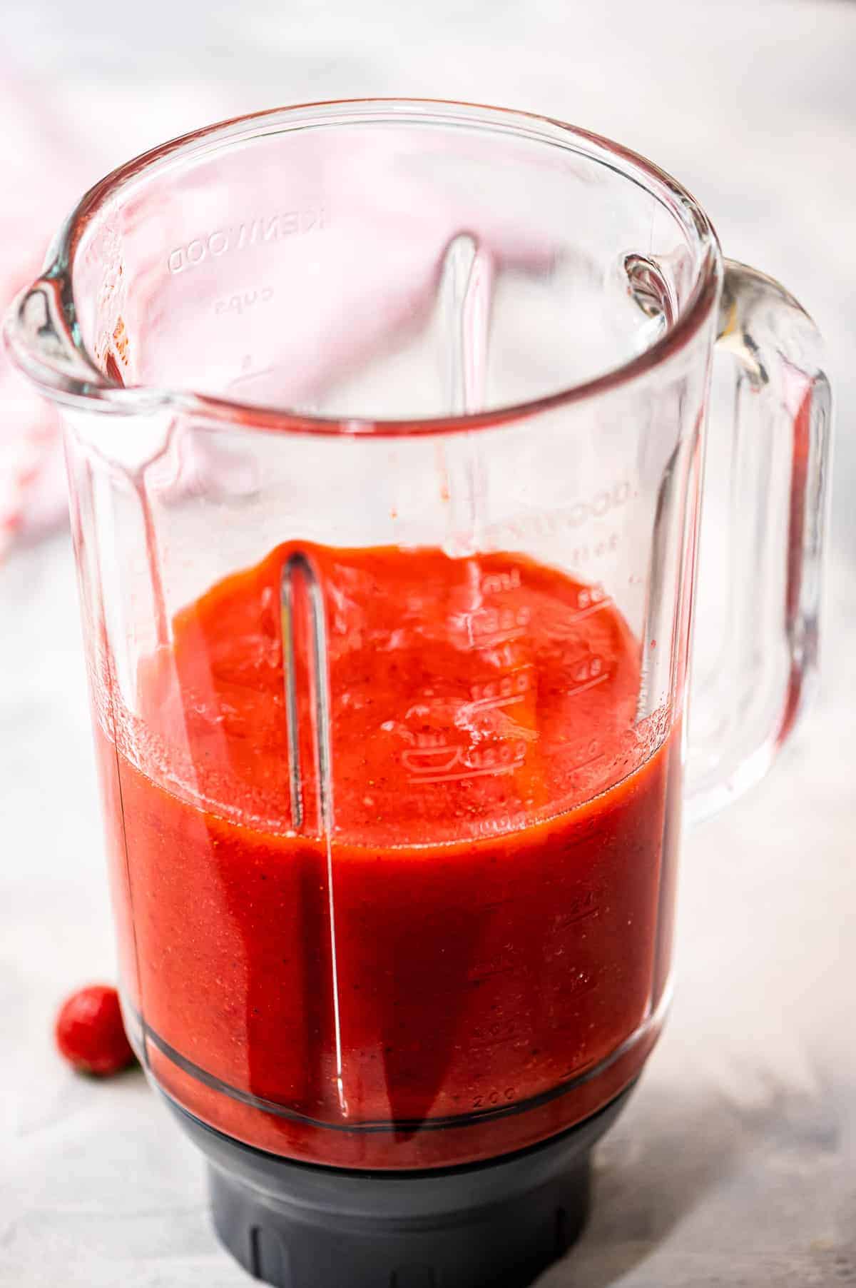 Blender with strawberry daquiri mixture in it