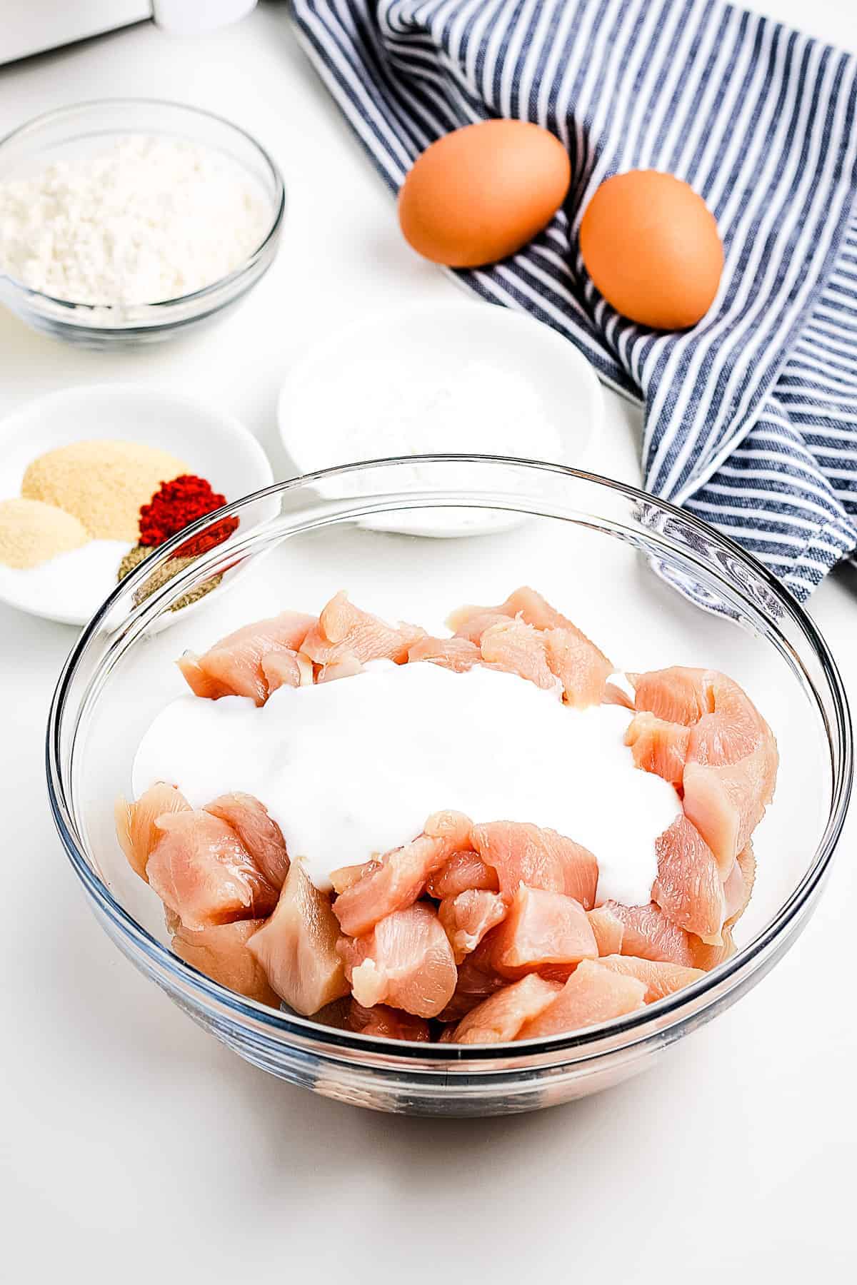 Chicken pieces in a bowl with buttermilk