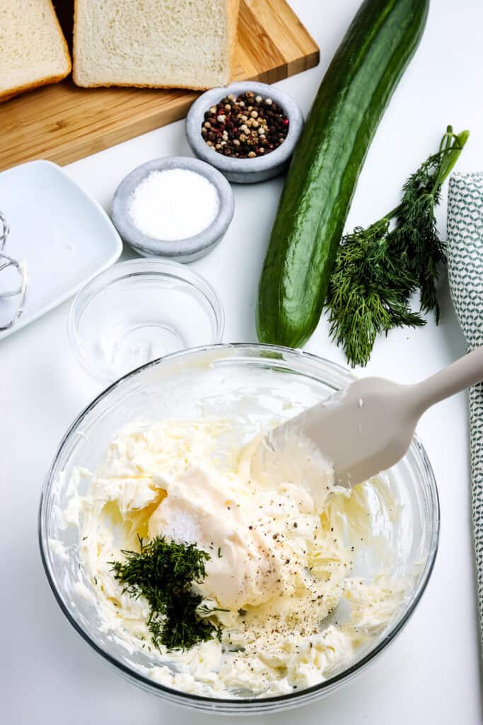Glass bowl with cream cheese, mayonnaise, dill, salt and pepper