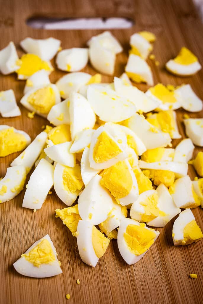 Wood cutting board with diced hard boiled eggs