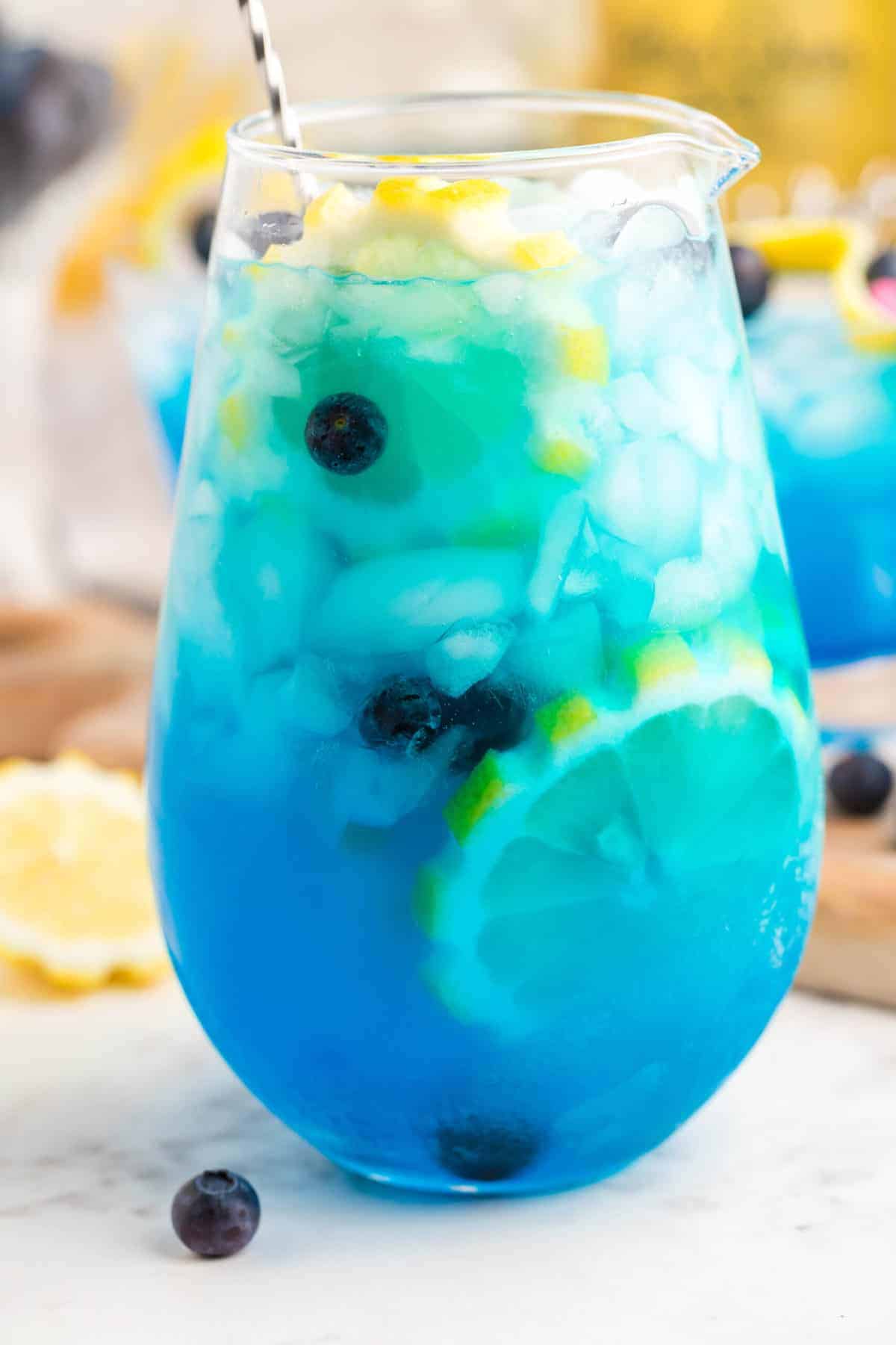 Collection of different summer party drinks in batch glasses