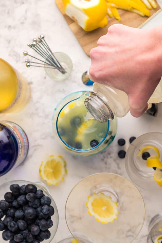 Pouring lemonade into cocktail